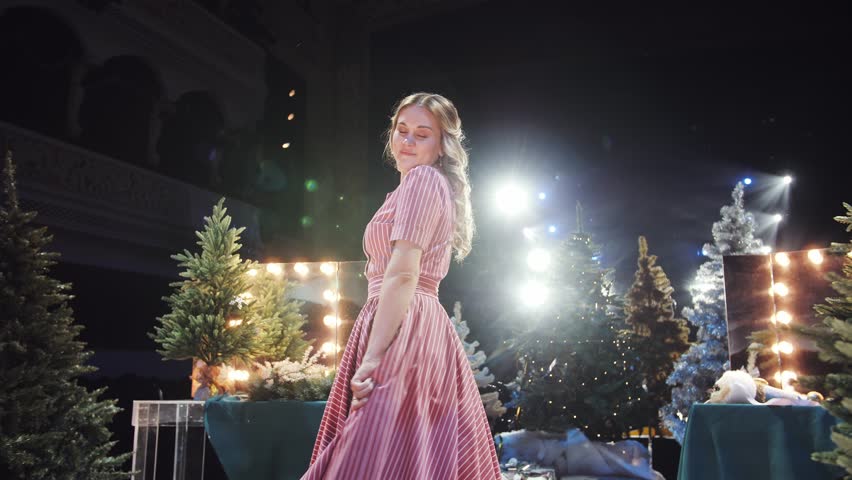 Joyful woman celebrating Christmas with festive confetti.