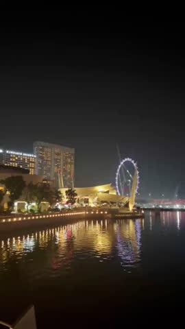 The spectacular view of Marina Bay Sands building, Singapore Flyer, and the skyscrapers at night.