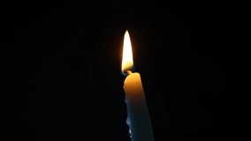 Macro footage of a candle flame flickering gently in darkness. The candle burns quietly, creating a peaceful and intimate atmosphere. Wax slowly melts and drips, then the flame extinguishes and elegant smoke fills the air. - Powered by Shutterstock - Get 15% off with code: PIKWIZARD15