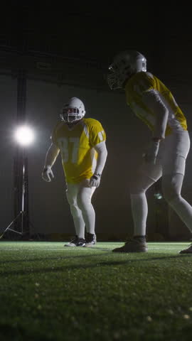 Full vertical shot of American football quarterback in blue jersey spurting downfield to advance ball to end zone, then getting tackled by rival team players in yellow uniforms