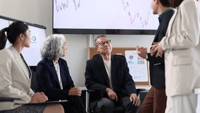 Diverse business team, including senior and young professionals, celebrating positive outcomes during a meeting. - Powered by Shutterstock - Get 15% off with code: PIKWIZARD15