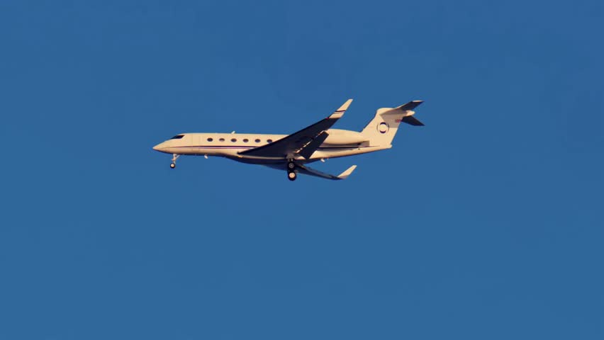 Airplane soars through a clear blue sky over Nice, France, showcasing aviation, travel, and the freedom of daylight flight.
