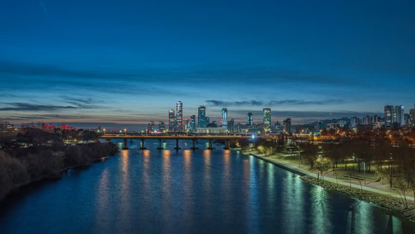 4K city skyline night to day time lapse video of skyscraper at Yeouido and Han river in Seoul, South Korea at sunrise time.