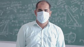 Indian Male Teacher Teaching In The Classroom Wear Safety Mask. Education in india. - Powered by Shutterstock - Get 15% off with code: PIKWIZARD15