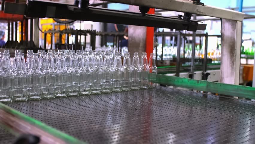 Glass factory, production of glass containers. Packaging of food containers. Robotics in industry. Modern technologies, robotic machines produce products. Technological work at the plant.