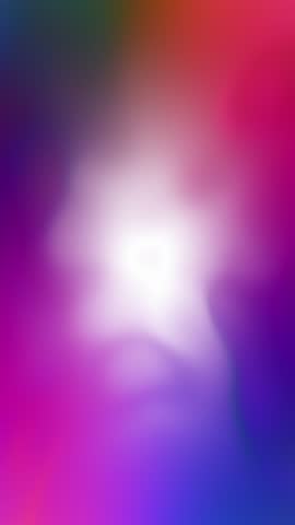 Multicolored blurred light seamless looping slow motion animation. Vertical background.