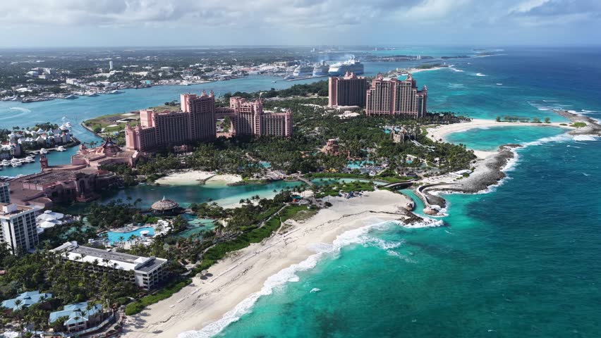 Atlantis Hotel In Nassau New Providence Bahamas. Modern Glass Skyscraper Soars Above A Bustling City. Coast Sky Seaside Summertime. Coast Remote Location Travel. Nassau New Providence.