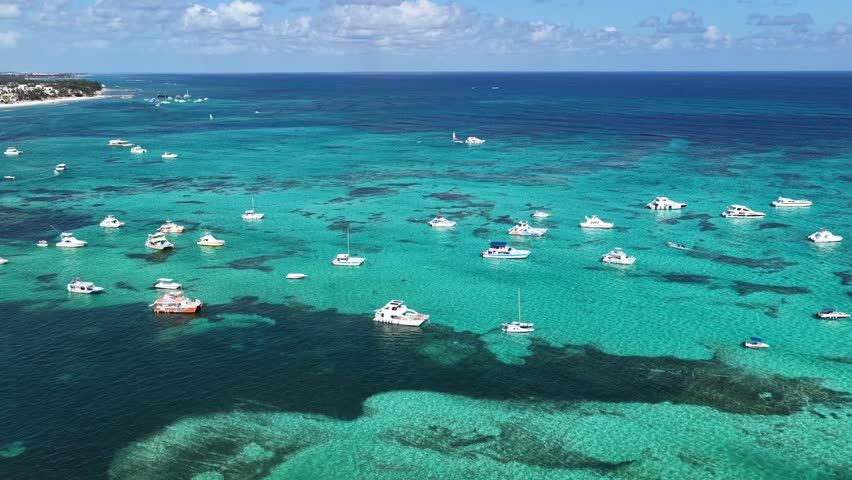 Punta Cana Skyline In Bavaro Punta Cana Dominican Republic. Breathtaking Aerial View Of Boat Sailing In A Wonder Scene. Shore Clouds Sky Beach Sea. Shore Seaside Scenic Coastline. Bavaro Punta Cana.