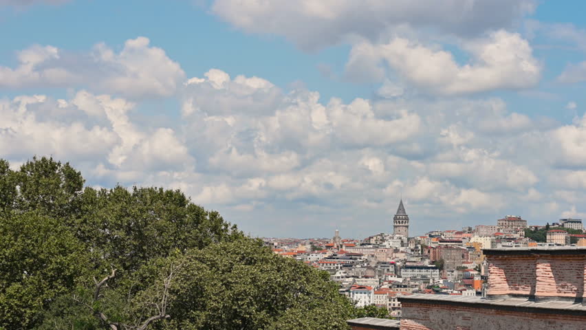 Istanbul, Turkey, August 1, 2025. Majestic galata tower rising above istanbul’s historic skyline under drifting white clouds and a bright summer blue sky.Zoom in.