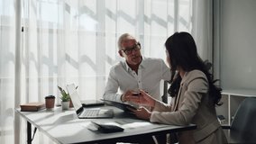 Professional diverse business people working together in a modern office. A senior manager and a young assistant analyzing data and graphs - Powered by Shutterstock - Get 15% off with code: PIKWIZARD15