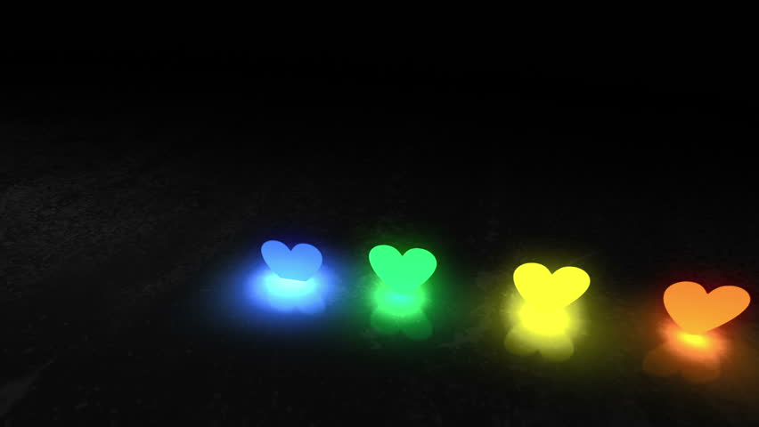 The dark background. Multi-colored spotlights shining heart-shaped appear from