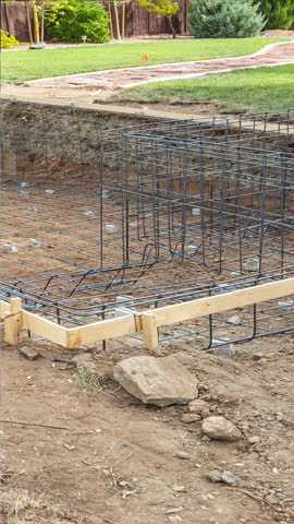 Seamless looping before-and-after of swimming pool construction, transitioning from rebar structure to a finished backyard pool with stonework, flowing water, and landscaping. Ideal for construction progress, renovation timelines, home improvement marketing, real estate, and contractor portfolios. Clean camera angle and smooth reveal allow text overlays and branding.