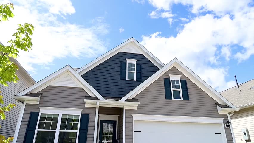 Modern suburban family house with driveway and garage.