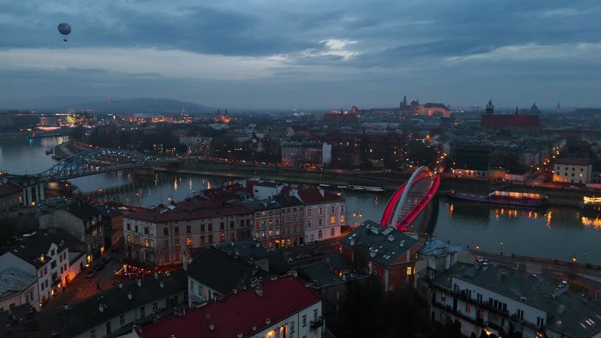 Drone view of bridges over the Vistula (Wisla) River at dusk in Krakow, Poland