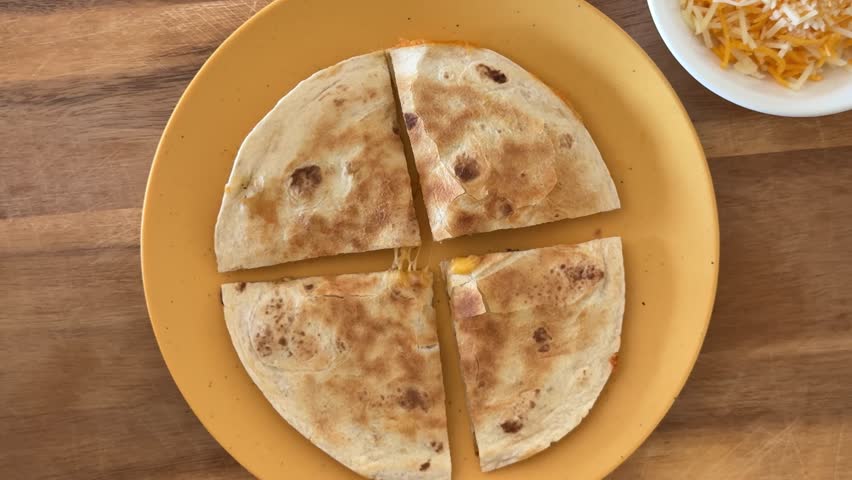 Eating a Cheese Quesadilla with Flour Tortillas and Cheese Shot From Above