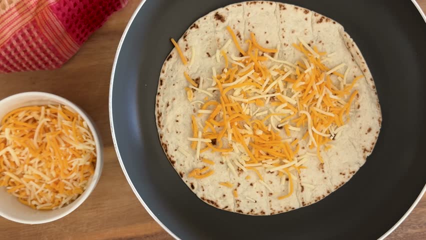 Making a Cheese Quesadilla with Flour Tortillas and Cheese Shot From Above
