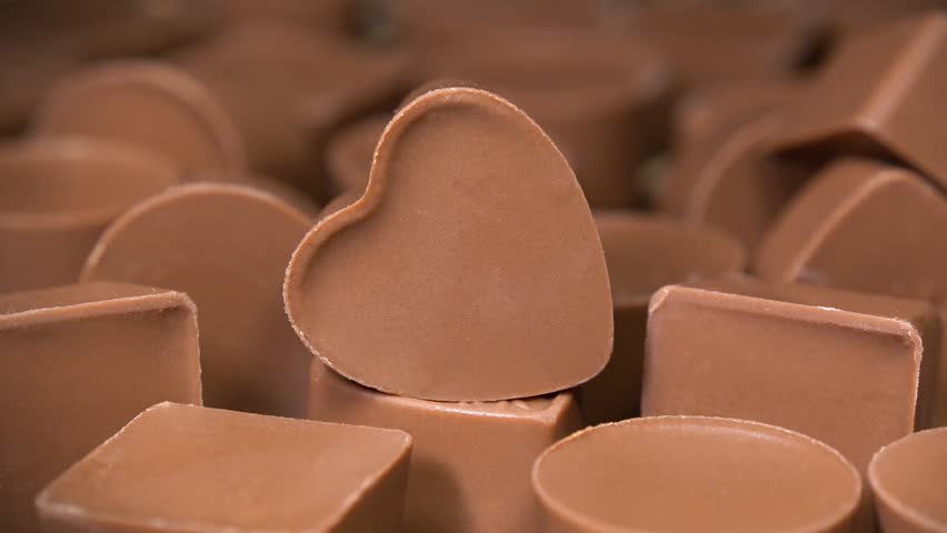 Heart-shaped chocolate candy. Sweetness, pleasure and love. Delicious heartfelt gift on Valentines Day