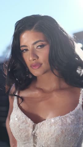 Beautiful bride wearing wedding dress looking at camera