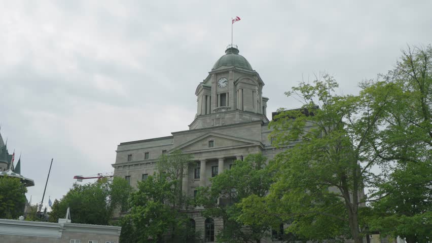 Historic Quebec City building in cloudy weather with trees nearby
