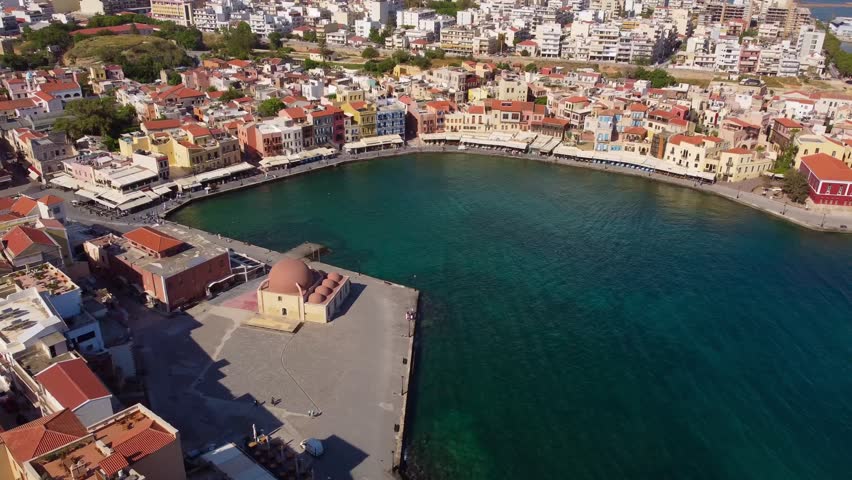 Aerial footage of Chania’s Venetian Harbour in Crete, featuring the Küçük Hasan Mosque and colourful waterfront buildings - Chania Old Town, Crete