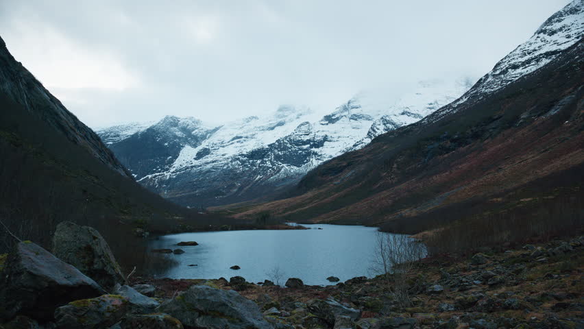 Scenic view of a valley in Norway in the winter with mountains covered with snow and a lake in the middle