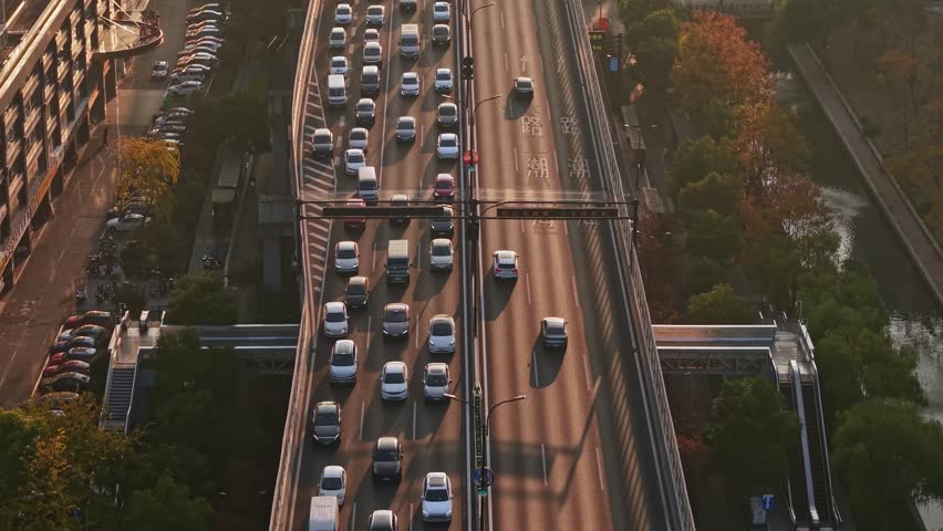 Traffic flows smoothly on a busy highway in Hangzhou, China during the late afternoon light
