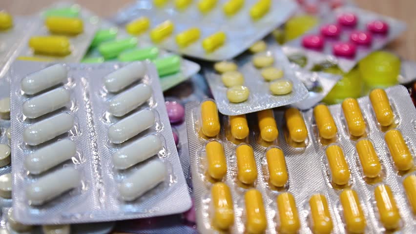 close up of hand holding pills