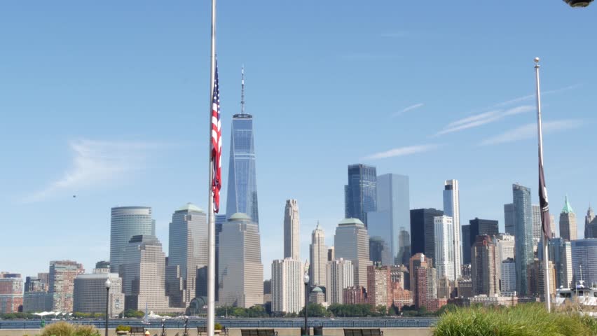 New York City Manhattan Downtown Financial District skyline, World Trade Center, New Jersey Liberty state park, United States. Hudson river waterfront cityscape, skyscraper building. American USA flag
