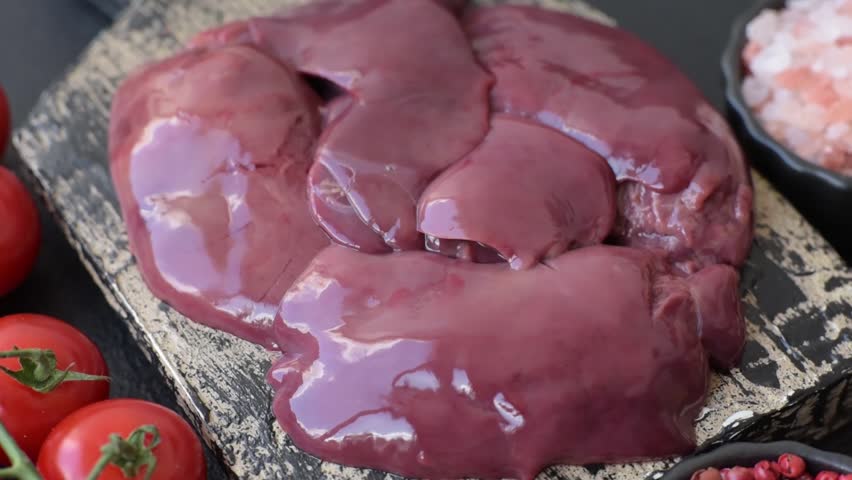 Raw fresh chicken or turkey liver, internal offal of poultry as an ingredient for cooking. Raw chicken liver as a food background