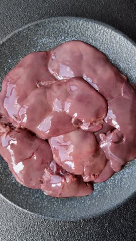Raw fresh chicken or turkey liver, internal offal of poultry as an ingredient for cooking. Raw chicken liver as a food background