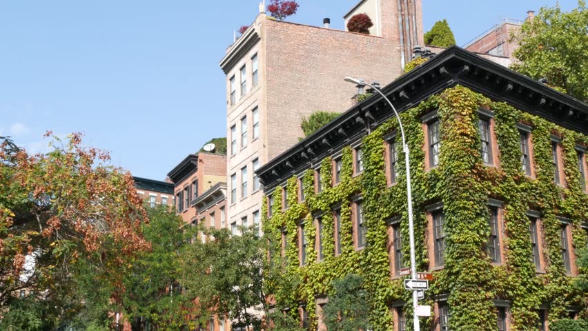 New York City urban residential buildings architecture, Lower Manhattan West village Greenwich street corner, United States of America. Greenwich village, USA. Red brick house. Vine greenery on wall.