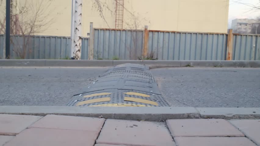 the car drives over a speed bump