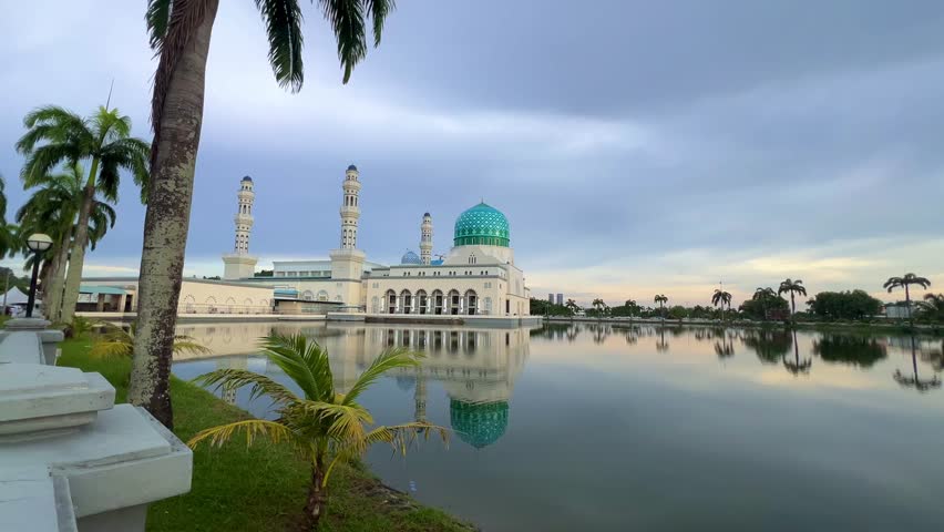 Malaysia - 31.06.2025: Bandaraya City Mosque on the shores of Likas Bay in Kota Kinabalu, Sabah. A beautiful floating mosque in Southeast Asia during the summer, with a reflection in the water. 4К