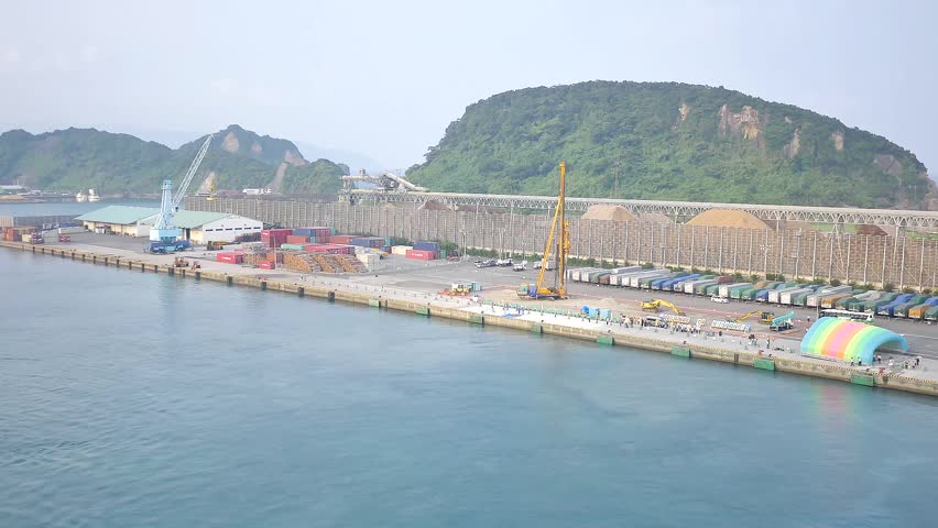 A cruise ship approaches Aburatsu Port in Miyazaki Prefecture revealing calm waters coastal hills and the harbor docking facilities