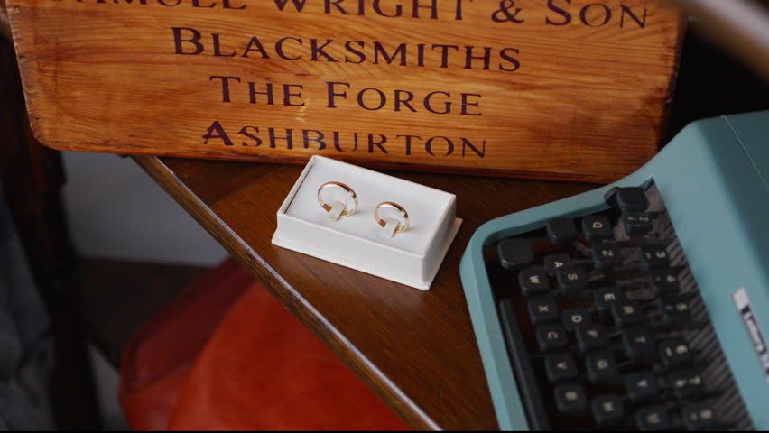Rings, a keyboard, and a vintage sign exude nostalgic charm