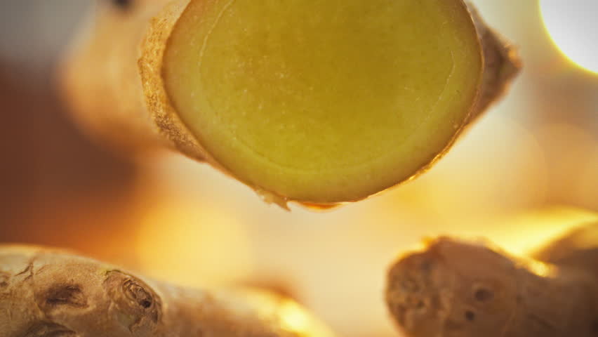 A vibrant ginger root is freshly sliced, releasing a stream of pungent ginger juice rich in vitamins and fibers, emphasizing the beneficial details of the natural extract