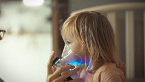 Caring mom administers medication treatment to her child using a nebulizer device, carefully securing the mask to their face for effective inhalation therapy, prioritizing their health and well-being - Powered by Shutterstock - Get 15% off with code: PIKWIZARD15