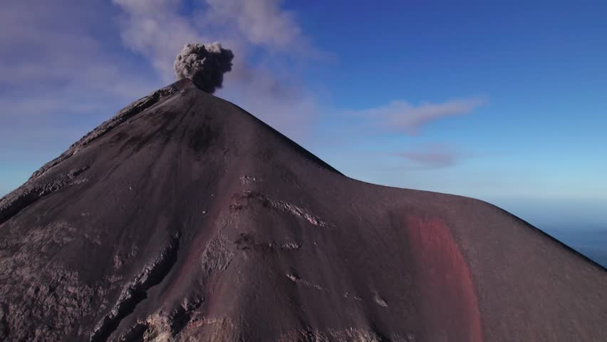 Acatenango, Guatemala - A Dark Volcanic Cone Rises Sharply as a Thick Plume of Ash Billows from its Summit - Tilt Reveal Drone Shot