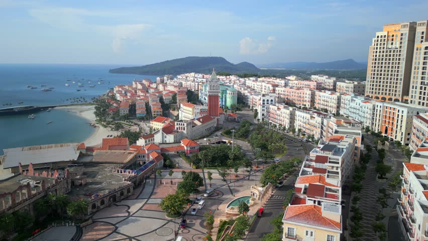 Aerial drone view of Sunset Town on Phu Quoc Island, Vietnam, showcasing colorful coastal architecture, seaside promenade, urban resort area, and tropical island atmosphere.