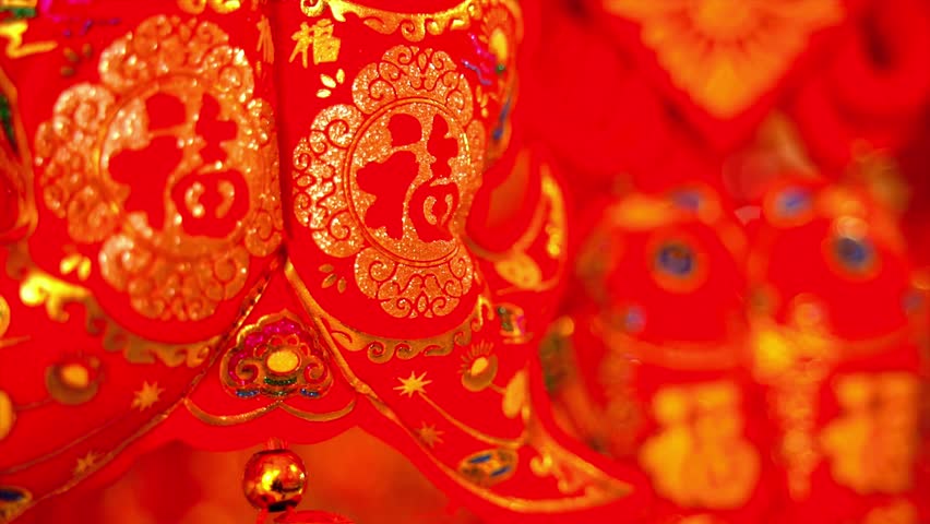 This video showcases a vibrant red and gold ornate fabric with intricate patterns and designs. The close-up shot highlights the luxurious texture and decorative elements of the fabric, creating a festive and celebratory atmosphere. The blurry background adds depth to the video, while the golden accents shine brightly, giving it an elegant and sophisticated feel.