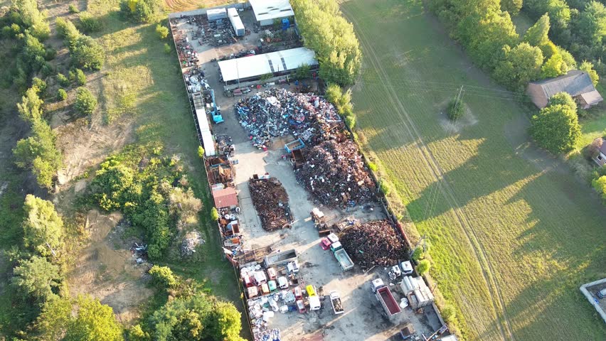 Scrapyard with machinery and metal heaps