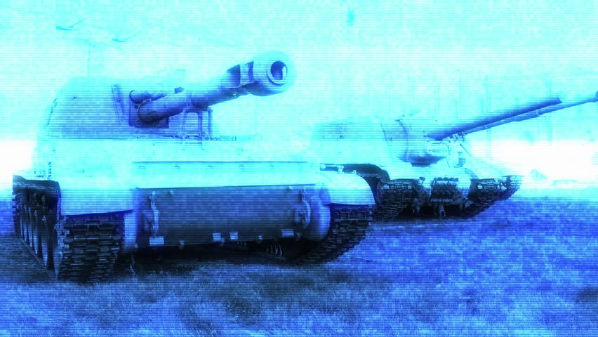 Two armored vehicles resting on a grassy area.