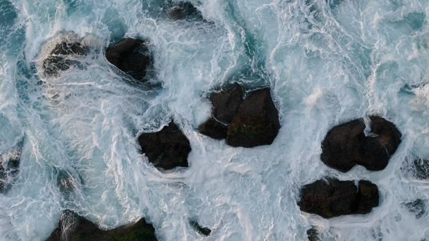 Top down aerial view of powerful ocean waves with white foam in the Atlantic Ocean.