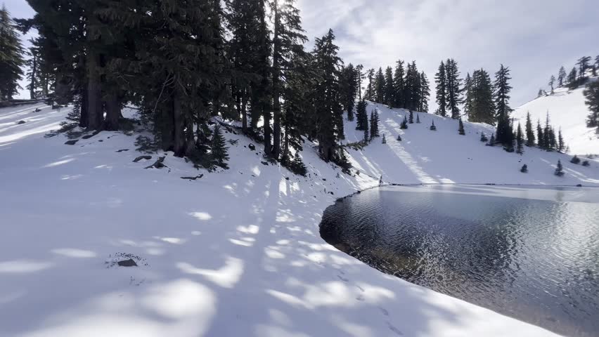 Snow covered landscape surrounding the Ridge Lake with icy volcanic peaks at Lassen Volcanic National Park