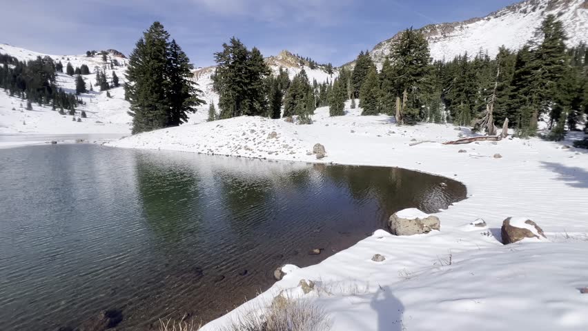 Snow covered landscape surrounding the Ridge Lake with icy volcanic peaks at Lassen Volcanic National Park