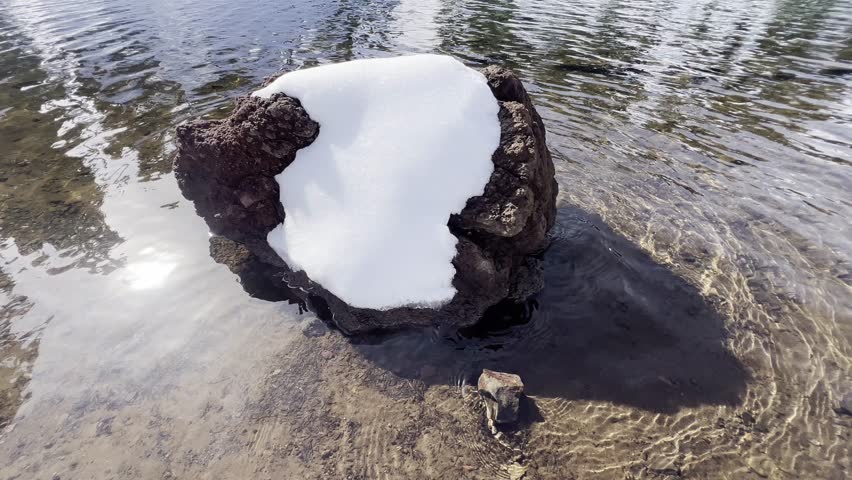 Snow covered landscape surrounding the Ridge Lake with icy volcanic peaks at Lassen Volcanic National Park