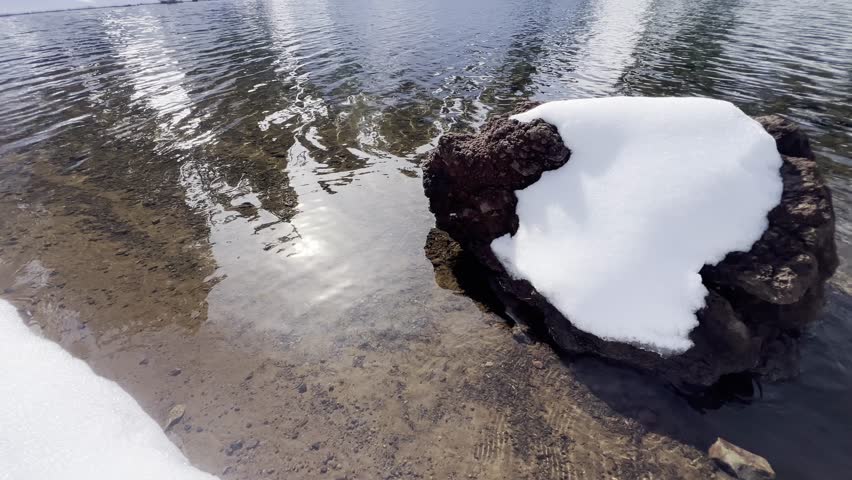 Snow covered landscape surrounding the Ridge Lake with icy volcanic peaks at Lassen Volcanic National Park
