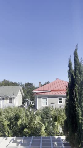 Clear Blue Sky Over Red Roofs and Palmetto Trees in Historic Charleston South Carolina Neighborhood