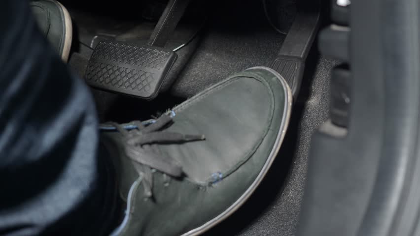 Accelerate and Brake. Foot pressing foot pedal of a car to drive ahead. Man driving car by pressing Accelerator and Brake in car. Driver driving the car by pushing accelerator pedals of vehical inside