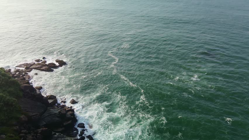 Ocean waves crash against the island
